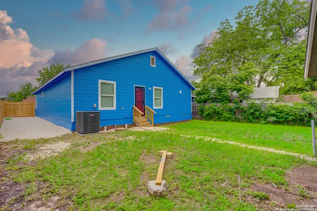 an aerial view of a house with a garden and swimming pool