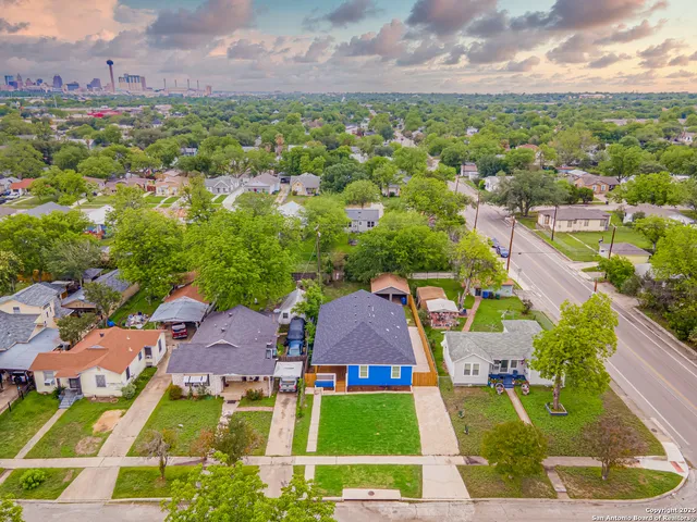 an aerial view of residential houses with outdoor space