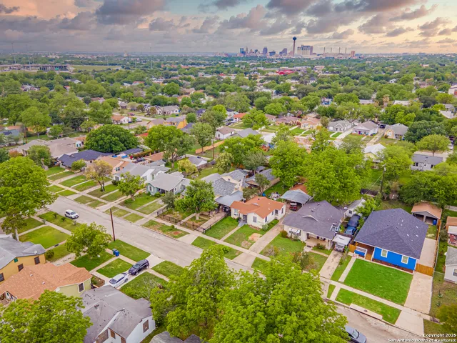 an aerial view of residential houses with yard