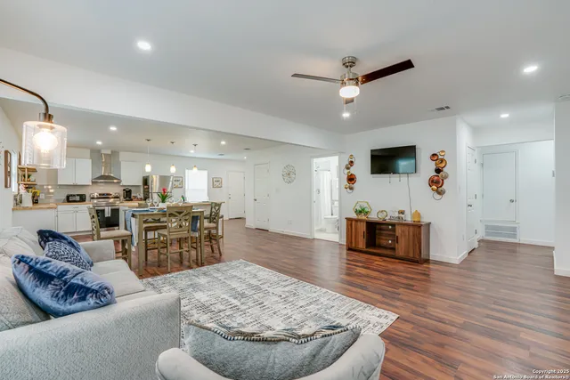 a living room with furniture and wooden floor