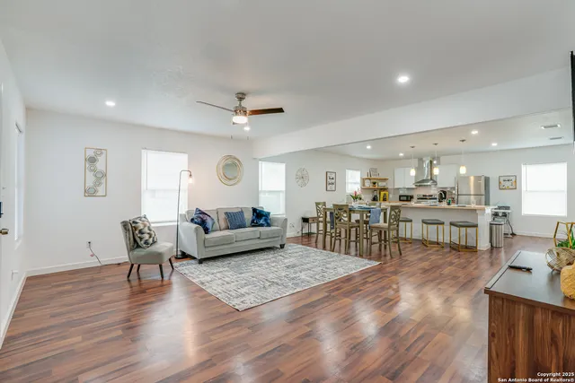 a living room with furniture and wooden floor