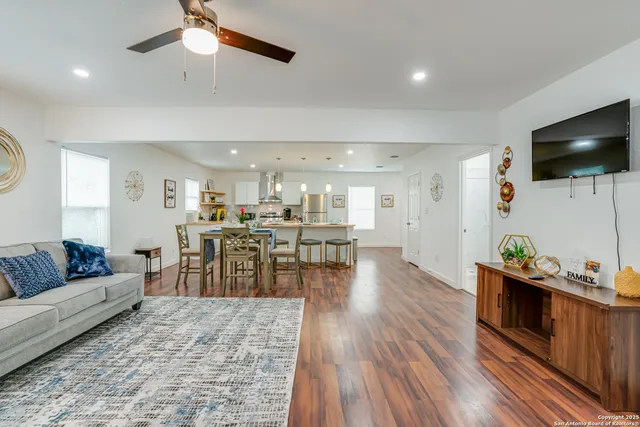 a living room with furniture and wooden floor