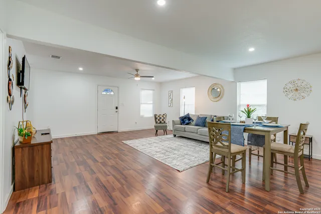 a view of a dining room with furniture and wooden floor