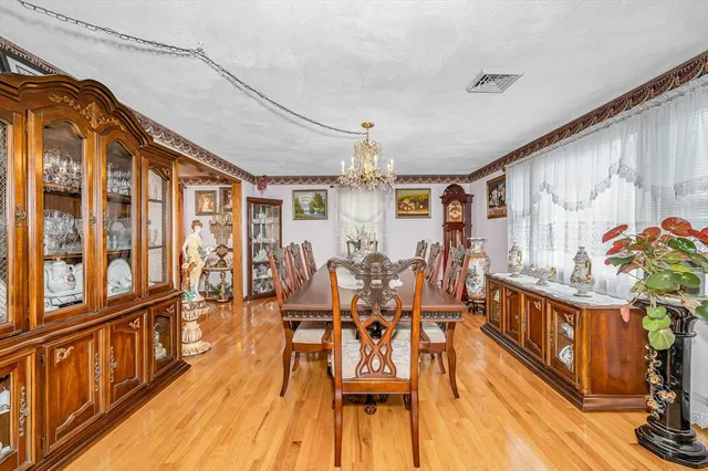 a view of a dining room with furniture wooden floor and chandelier
