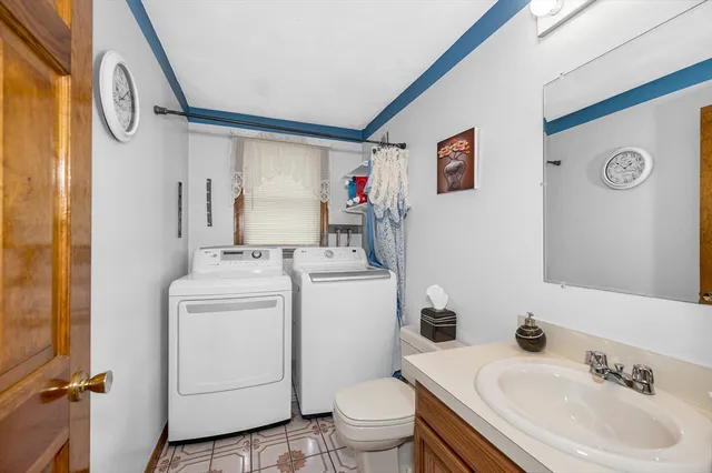 a bathroom with a sink toilet and a mirror