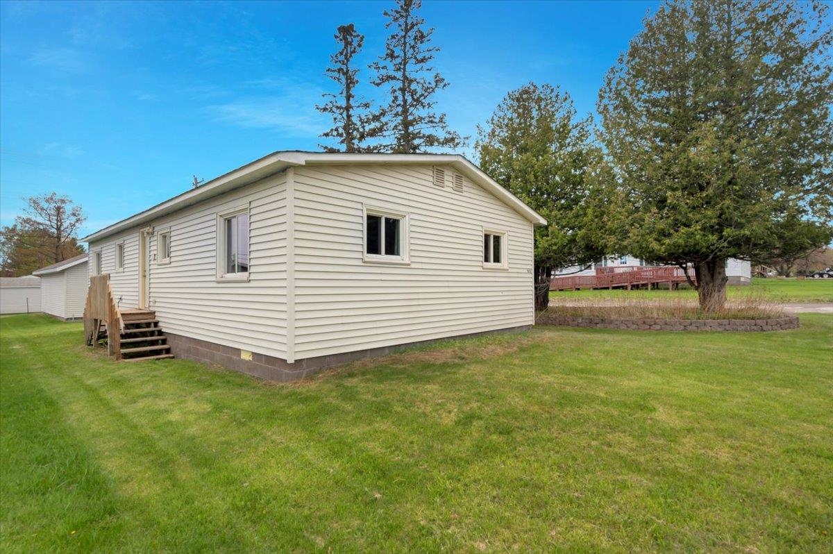 1632 9th Avenue Two Harbors, MN 55616 - Photo 16 of 21 View of property exterior featuring a lawn