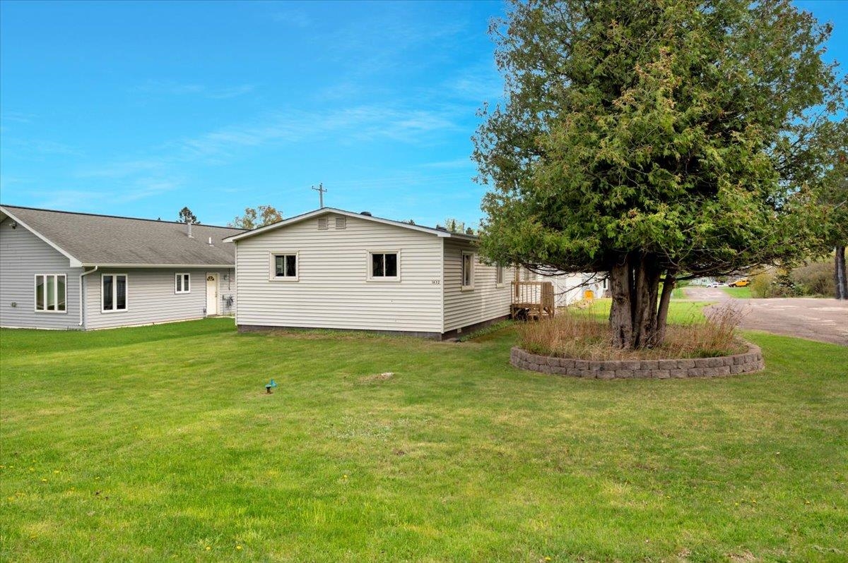 1632 9th Avenue Two Harbors, MN 55616 - Photo 17 of 21 Rear view of house with a lawn