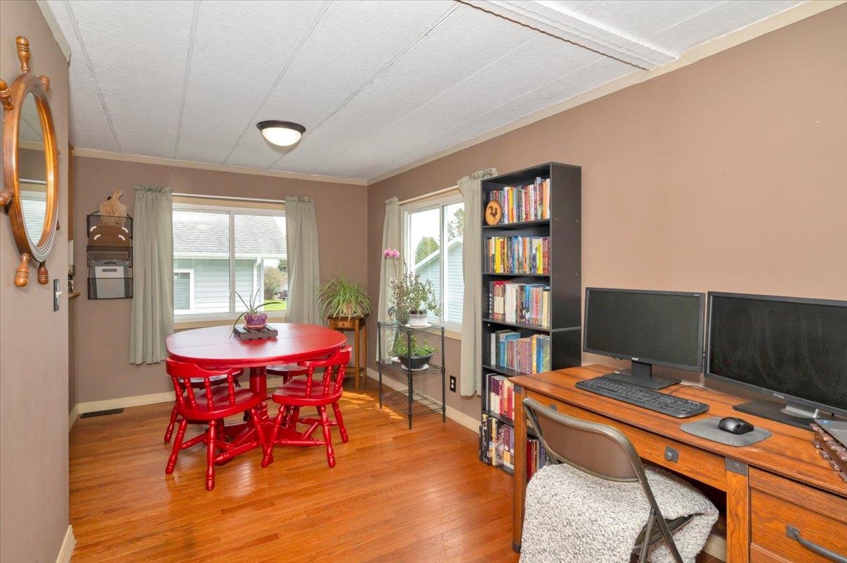 1632 9th Avenue Two Harbors, MN 55616 - Photo 6 of 21 Dining space featuring baseboards, light wood-style flooring, ornamental molding, and a desk
