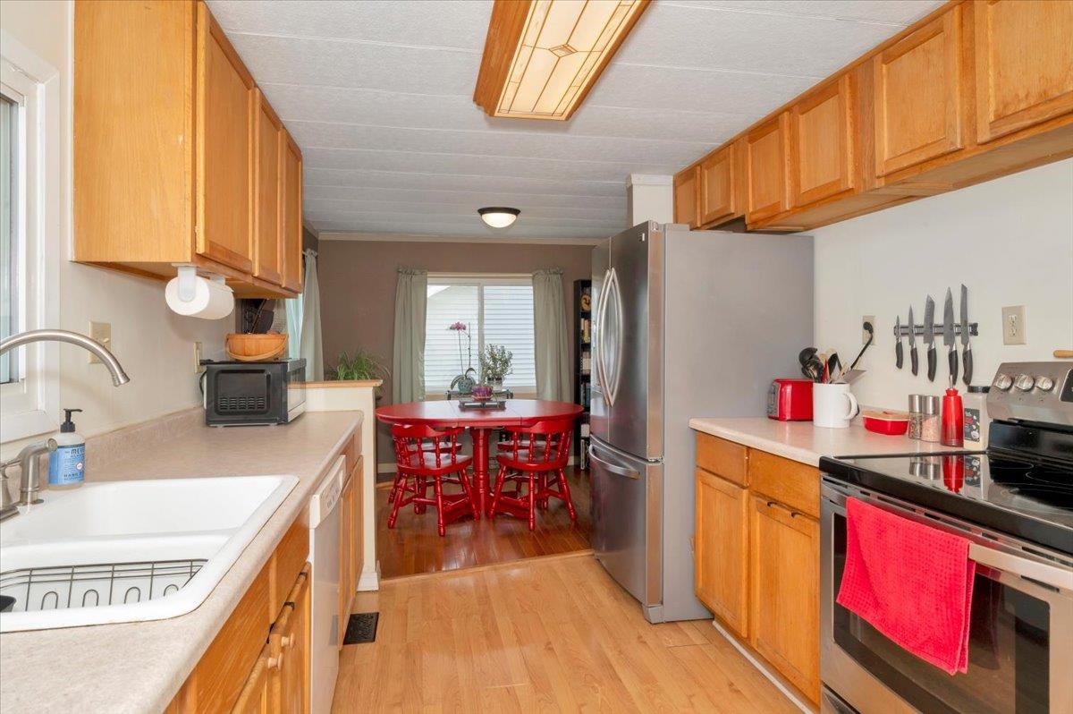 1632 9th Avenue Two Harbors, MN 55616 - Photo 9 of 21 Kitchen with stainless steel appliances, a sink, light wood-style floors, and light countertops