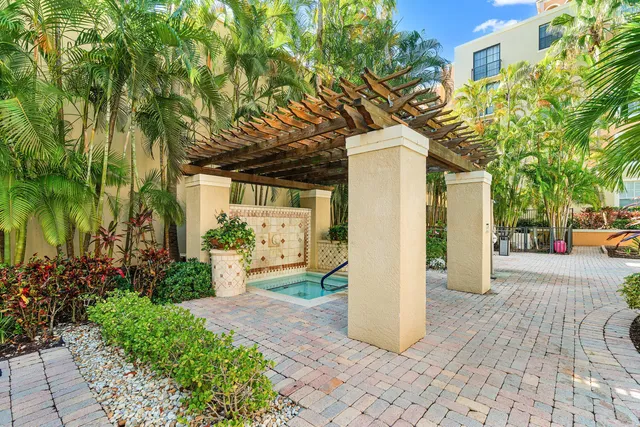 a front view of a house with a yard and plant