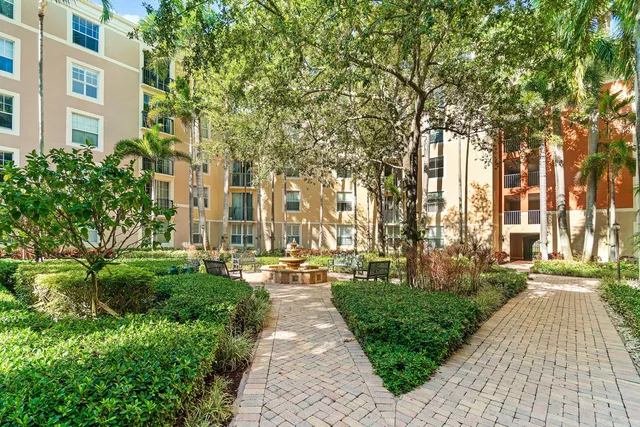 a front view of a building with a garden