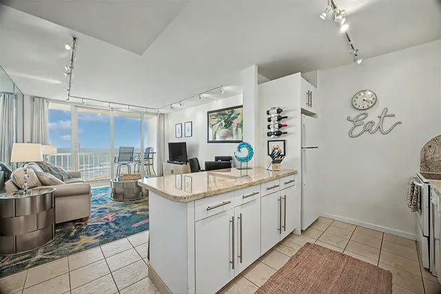 a kitchen with a sink and living room view
