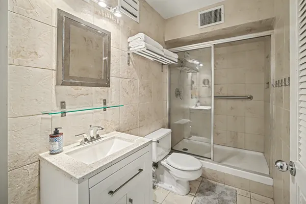 a bathroom with a sink toilet and shower