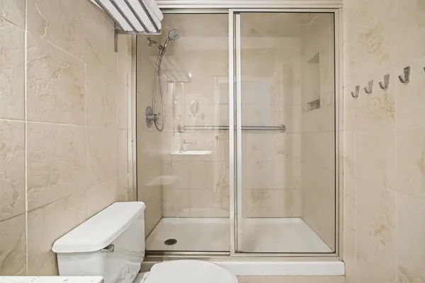 a bathroom with a shower and a toilet
