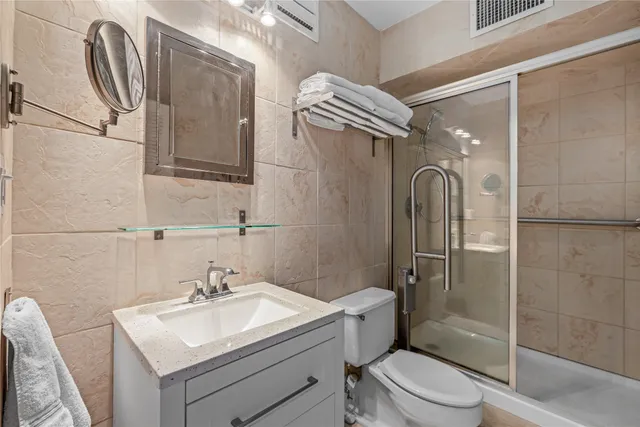 a bathroom with a sink toilet and shower