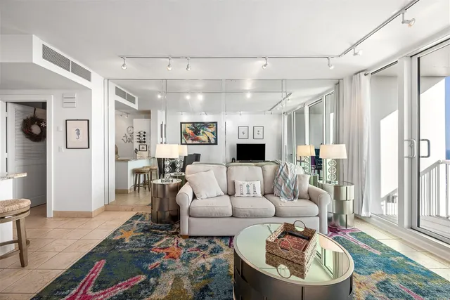 a living room with furniture and a wooden floor