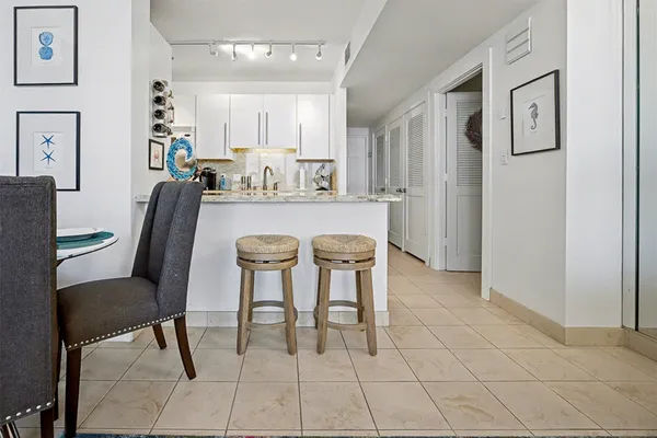 a dining hall with stainless steel appliances a table and chairs