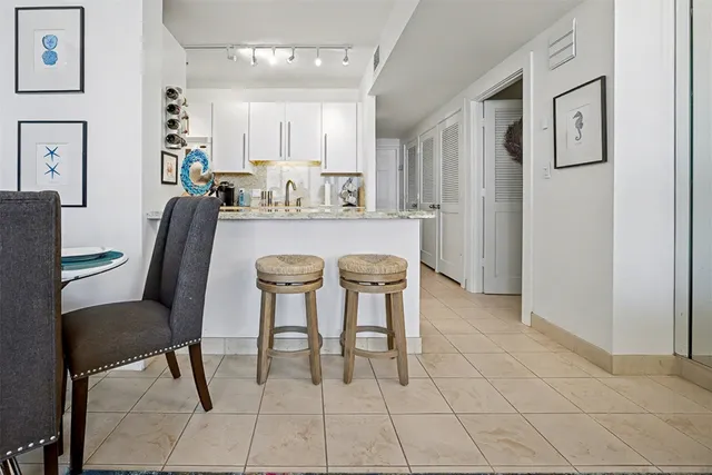 a dining hall with stainless steel appliances a table and chairs