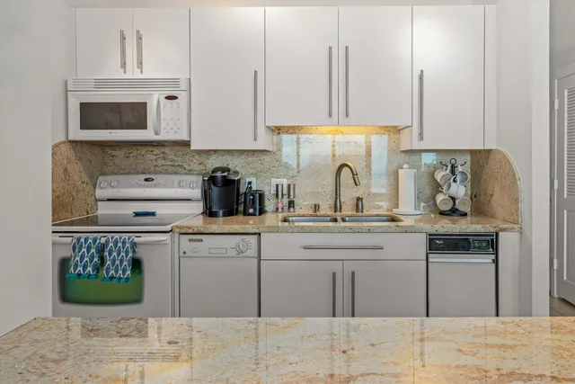 a kitchen with stainless steel appliances granite countertop a sink and cabinets