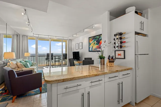 a very nice looking living room with a large window and a dining table