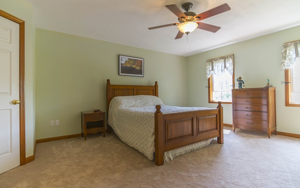 139 Rice Corner Road Brookfield, MA 01506 - Photo 12 of 24 a bed room with a bed and a chandelier