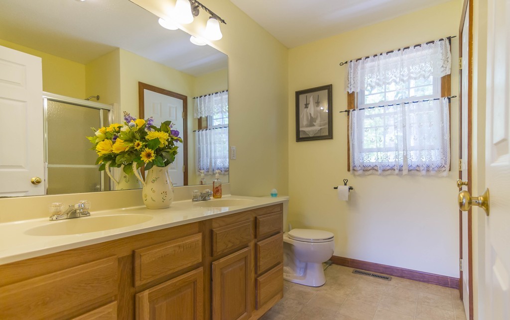139 Rice Corner Road Brookfield, MA 01506 - Photo 16 of 24 a bathroom with a granite countertop toilet sink and mirror