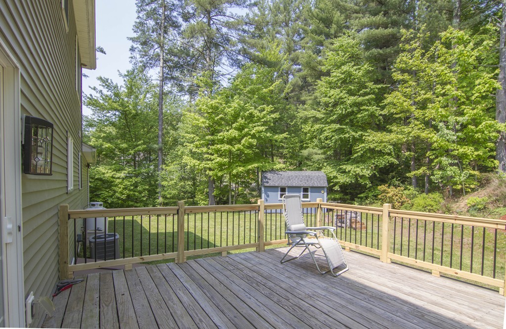 139 Rice Corner Road Brookfield, MA 01506 - Photo 18 of 24 a view of a deck with two chair and wooden fence