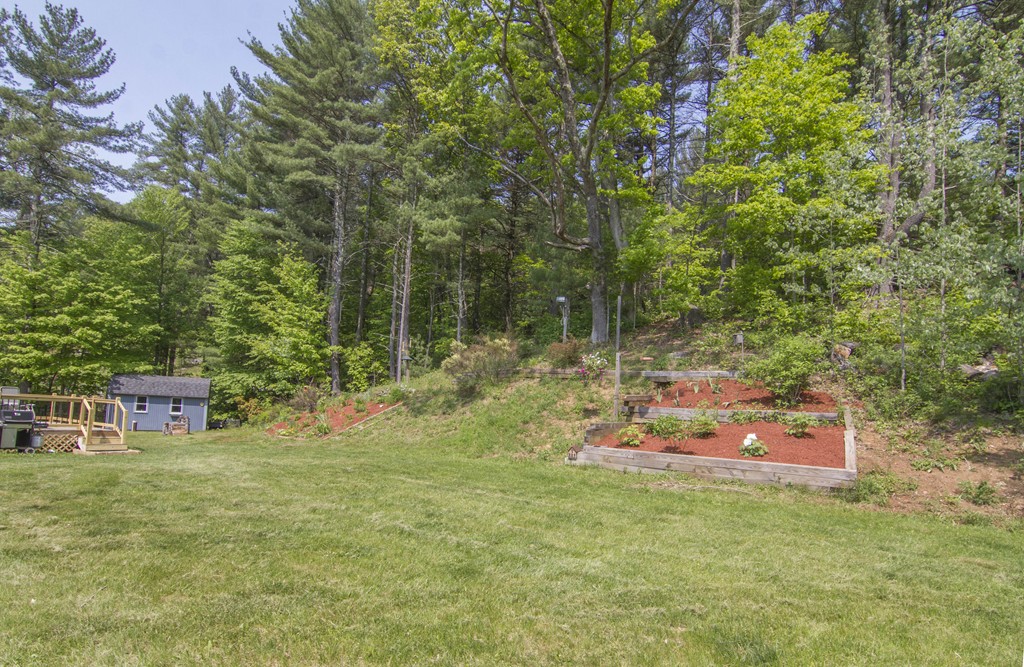 139 Rice Corner Road Brookfield, MA 01506 - Photo 20 of 24 a backyard of a house with table and chairs