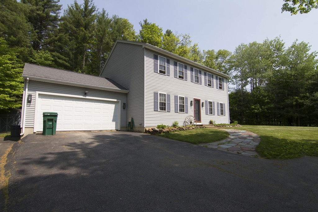 139 Rice Corner Road Brookfield, MA 01506 - Photo 22 of 24 a front view of a house with a yard and garage