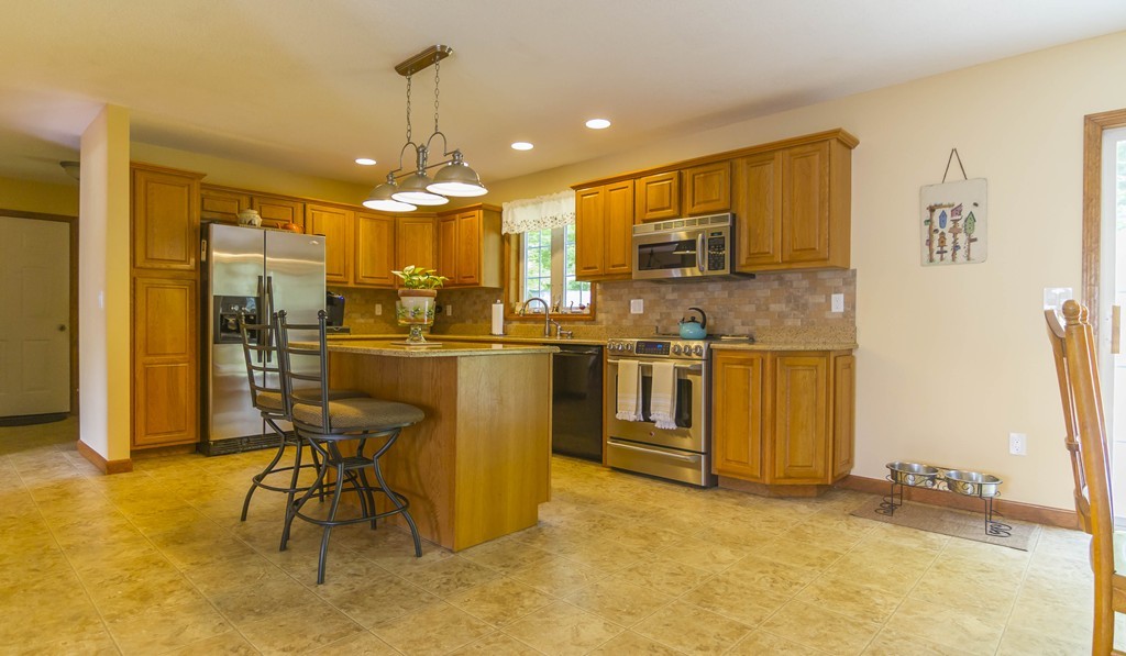 139 Rice Corner Road Brookfield, MA 01506 - Photo 3 of 24 a kitchen with stainless steel appliances granite countertop a sink and a refrigerator