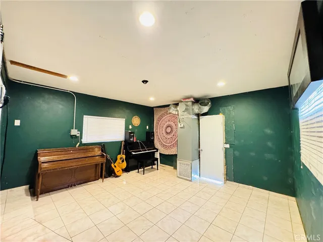 a bedroom with a bed and a pool table with a bookshelf