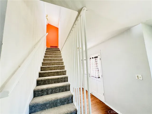 a bedroom with a bed and a large mirror