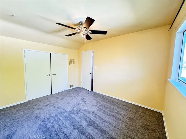 a view of staircase with railing and white walls