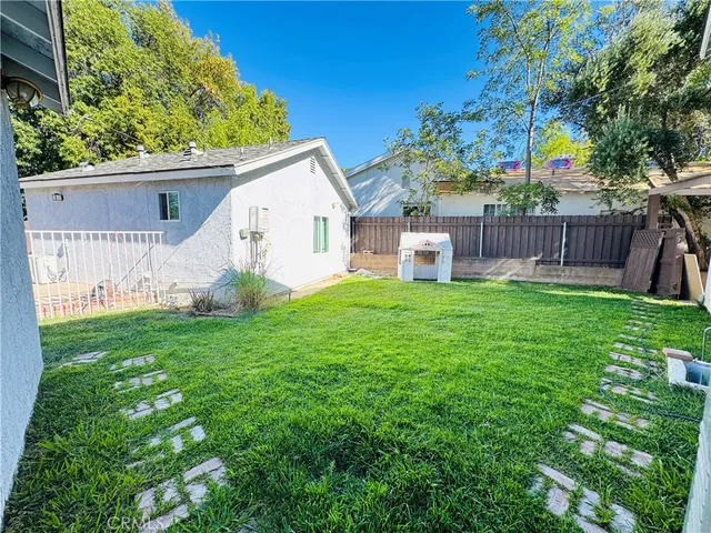 a view of a house with a yard and a garden