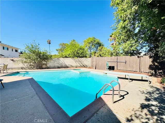 a view of a swimming pool with chairs