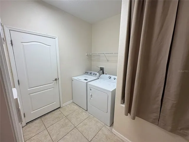 a utility room with cabinets washer and dryer