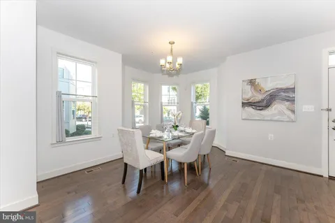 a dining room with furniture and wooden floor