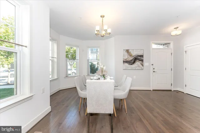 a kitchen with stainless steel appliances kitchen island granite countertop a sink a stove top oven a counter space and cabinets