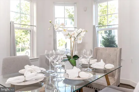 a kitchen with stainless steel appliances granite countertop a sink a stove top oven and cabinetry