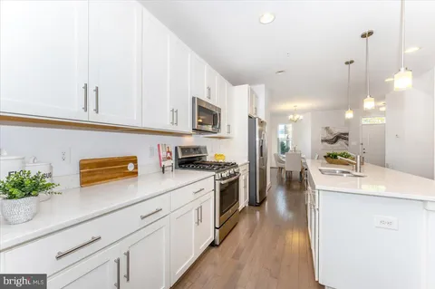 a view of staircase with wooden floor and white walls