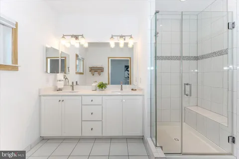 a bathroom with a granite countertop sink a toilet and a mirror