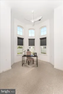 a living room with furniture a rug and a window