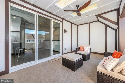 a backyard of a house with potted plants and large tree