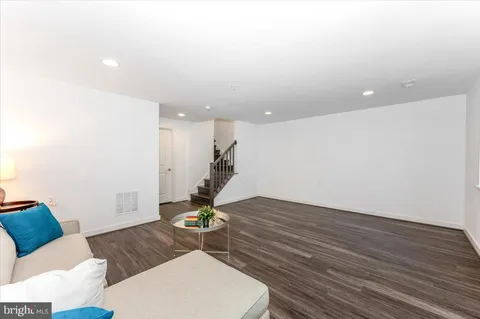 a front view of a house with a yard and potted plants