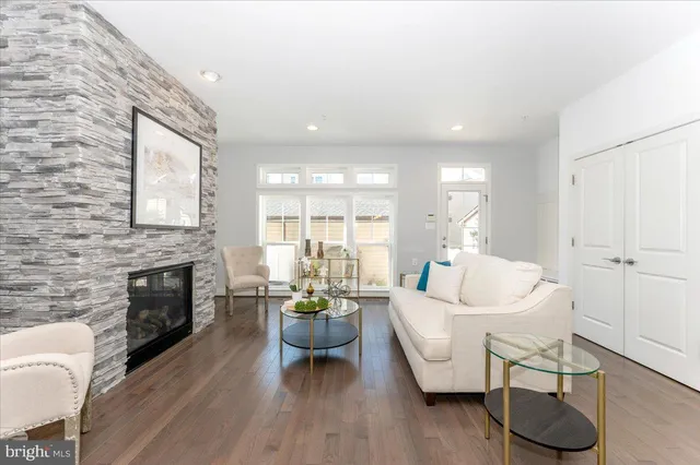 a living room with furniture a fireplace and a wooden floor