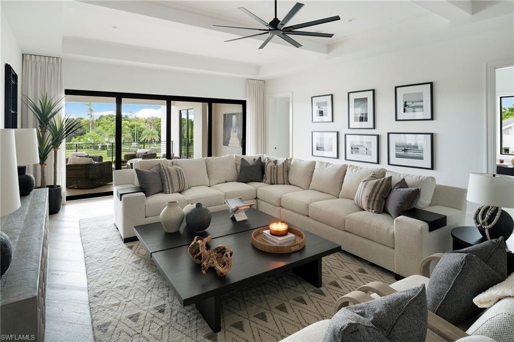6704 Newport Road Naples, FL 34109 - Photo 29 of 47 a living room with furniture and a large window