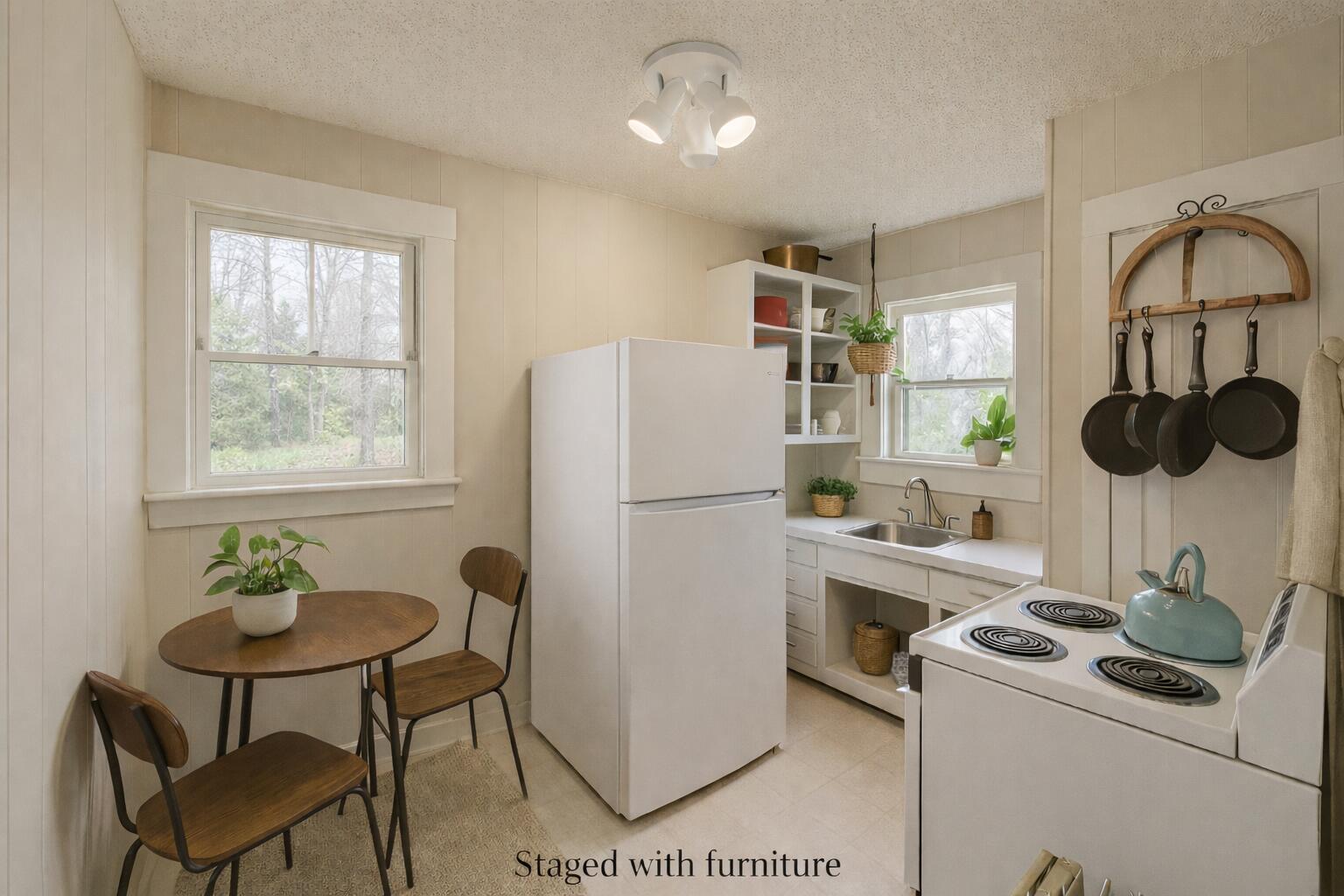 2432 22nd Street, Unit R Lubbock, TX 79411 - Photo 2 of 6 a kitchen with a refrigerator and a table