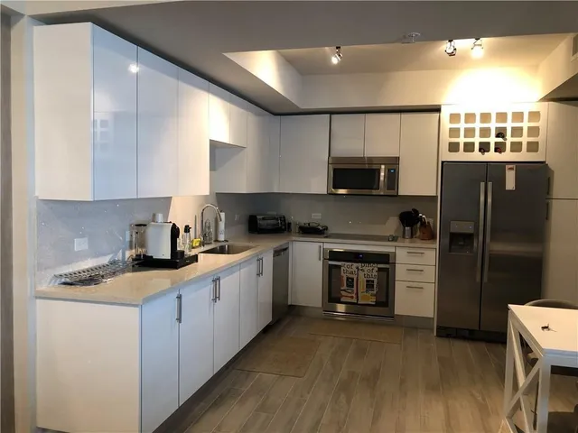 a kitchen with a refrigerator stove and microwave