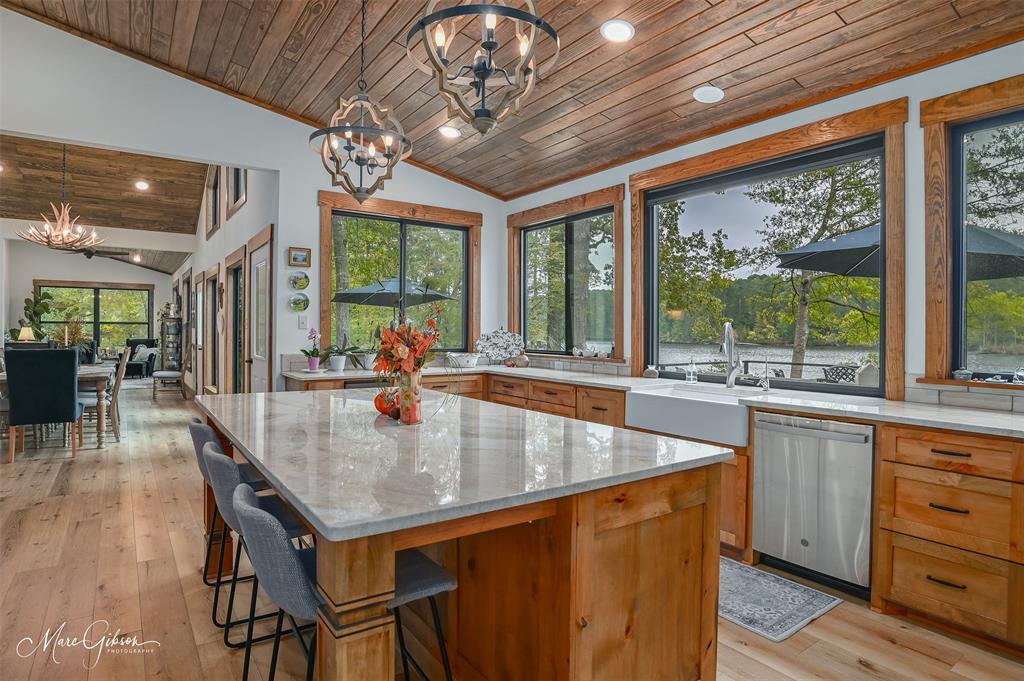 335 Coleman Loop Homer, LA 71040 - Photo 15 of 40 a dining hall with stainless steel appliances granite countertop a kitchen island a stove and a chandelier