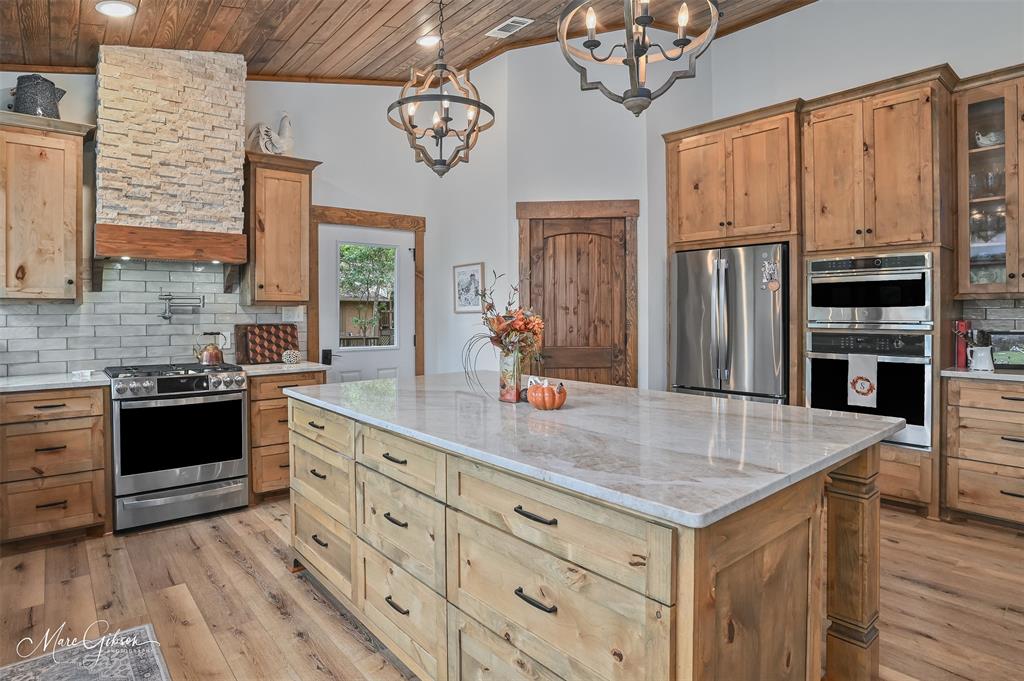 335 Coleman Loop Homer, LA 71040 - Photo 17 of 40 a kitchen with stainless steel appliances granite countertop a stove refrigerator and cabinets